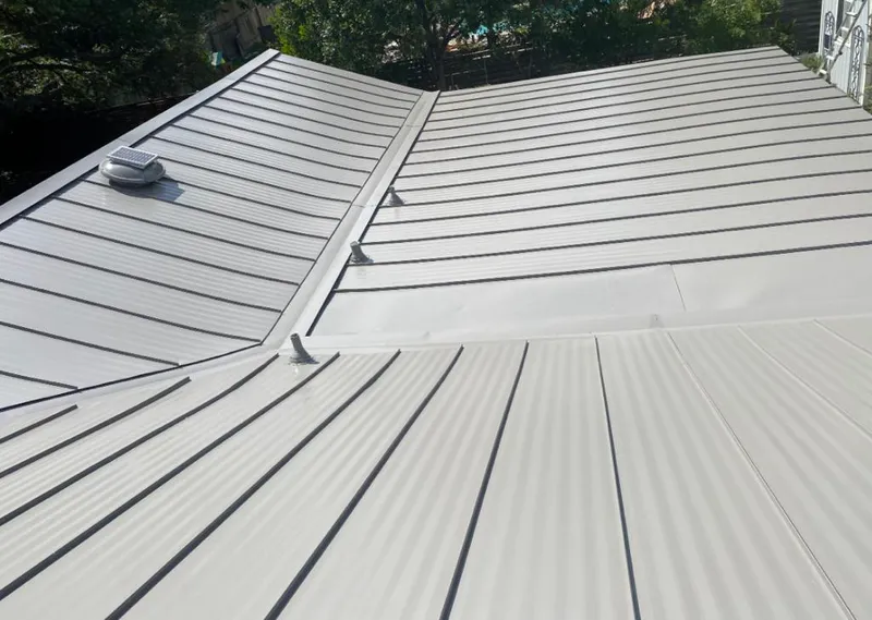 Solar attic fan installed on a metal roof for Roof Ventilation in Clover Creek